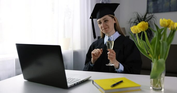 online graduation celebration - happy woman using laptop and drinking champagne together with university friends