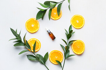 Composition with bottle of orange essential oil on white background