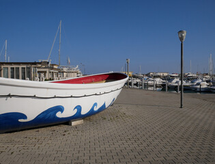 Naklejka na ściany i meble Termoli - Molise - In the foreground a boat and the tourist port