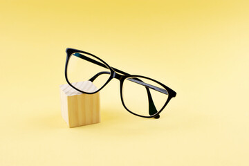Black Eyeglasses  On Yellow Background 