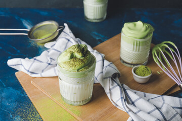 Composition with tasty dalgona matcha latte on table