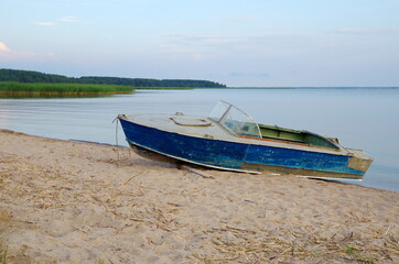 Boat on the shore of Lake Seliger on a summer evening. Tver Region, Russia