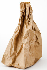 Crumpled paper bag with greasy spots on a white isolated background. Recycling of secondary waste