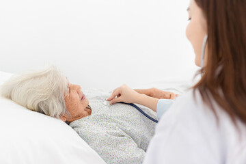 close up old patient, asian female doctor use stethoscope listening and screening old asian...