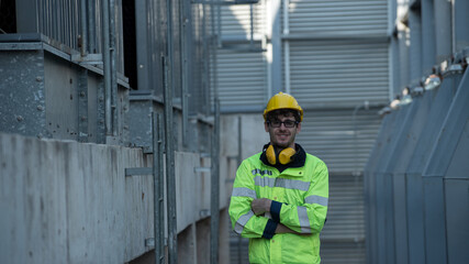 Confident supervisor cross arm on site Construction. Portrait worker in protective on construction site