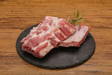 Raw pork ribs served rosemary