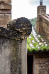 Architectural detail, Sovana, Italy. Tuscany. Fibonacci spirals and curves. The signs of time have left their traces. Blurred green background, moody day