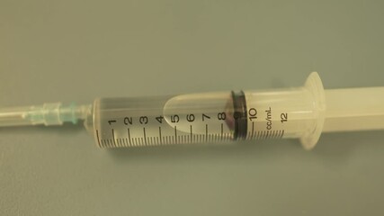 Close view of 10 ml plastic transparent syringe with drug medication within for patient treatment in hospital