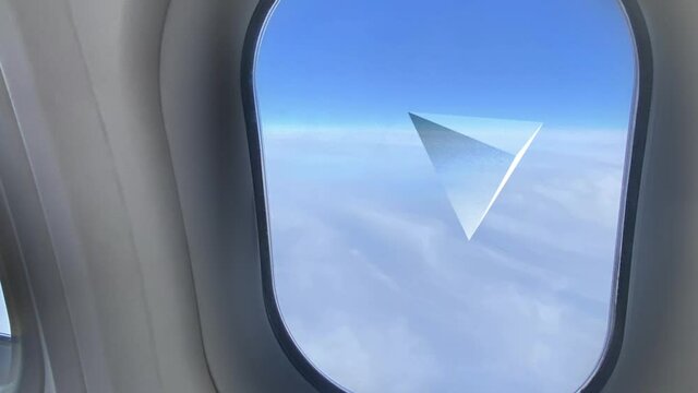 A passenger's view looking at a pyramid-shaped UFO outside the airplane.  	