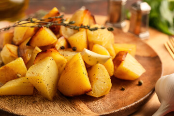 Plate of tasty baked potato with garlic, closeup