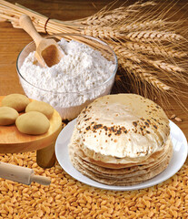 Rustic shot of a plate of chapati surrounded by ingredients