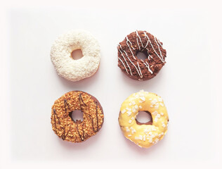 set of four multi-colored donuts in a square on a white background. pink toning. place for text 