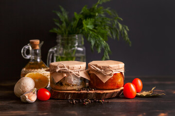 Homemade canned fish from mackerel in oil and tomato paste. Glass jars with canned fish