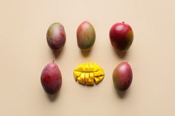 Sweet ripe mangoes on color background