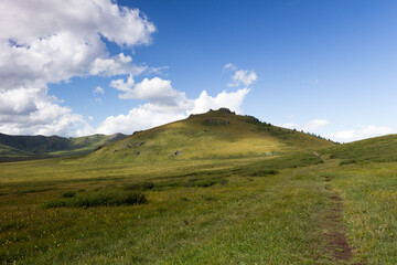 Green mountain valley and sky, travel..On the Oroy pass. Mountain Altai. Siberia. Russia.