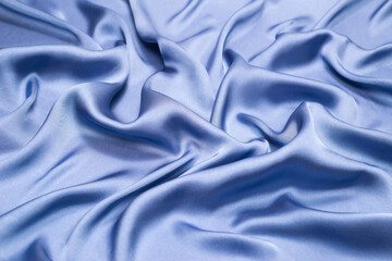 Obraz premium Blue silk or satin luxury fabric texture. Top view.