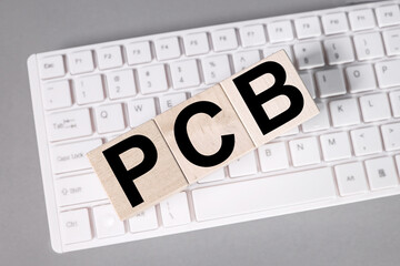 PCB - Printed Circuit Board acronym, technology concept background.
