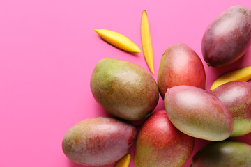 Sweet ripe mangoes on color background