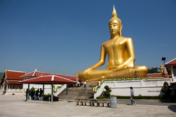Golden big buddha statue of Wat Bang Chak at riverside chao phraya river near Koh Kret island for thai people travel visit respect praying at Pak kret city on November 15, 2020 in Nonthaburi, Thailand