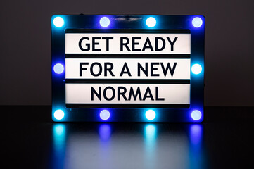 Lightbox with green and blue lights in dark room with words - get ready for a new normal