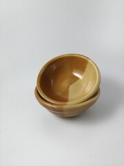 Two light and dark brown ceramic sauces that are used regularly at home.