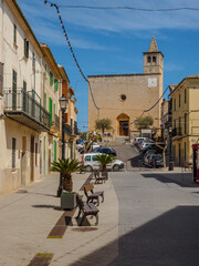 Main street with church in the background, Calle Major in the village of Buger on the balearic island of Mallorca, spain