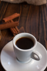 A cup of aromatic black coffee with steam coming from the mug. Morning espresso or Americano coffee for breakfast in a beautiful cup. Wooden background. Couple with coffee.