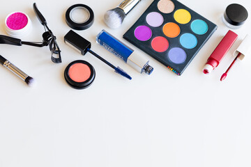 Bright multi-colored decorative cosmetics on a light background