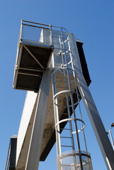 Close Up View of Steel Gantry and Ladder over Urban Motorway against Blue Sky