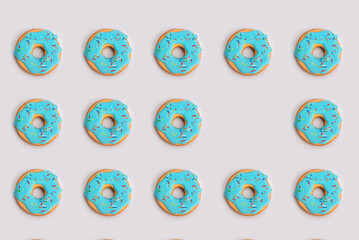 Background pattern of gingerbread donuts with one empty space at the gray background
