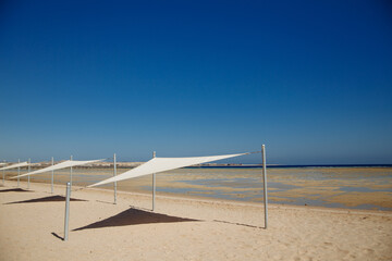 white beach awning on the Red Sea and blue sky