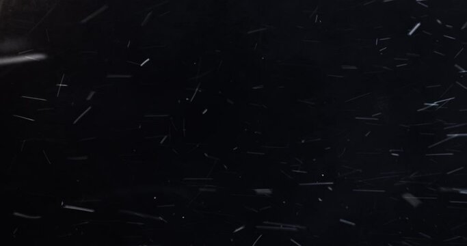 4k Slow-motion VFX Blizzard element. Dense heavy blizzard snowstorm VFX insert in slow-motion on black screen. Black screen Christmas snowstorm. Particles swirling moved by wind.
