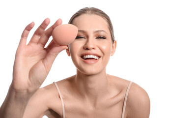 Beautiful young woman with makeup sponge on white background