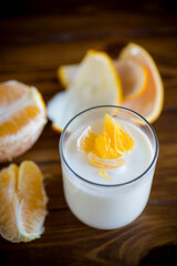 homemade sweet yogurt in a glass with oranges