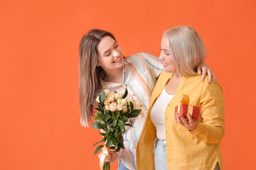 Young woman greeting her mom against color background