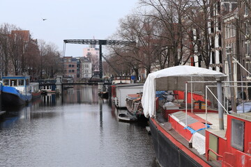 Fototapeta na wymiar Amsterdam Brouwersgracht Canal with Boats and Historic Iron Bridge