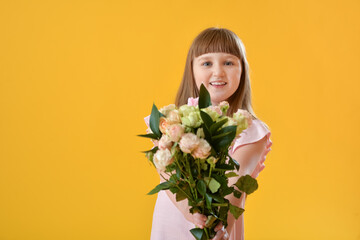 Cute little girl with bouquet of beautiful flowers on color background