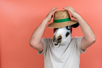 person disguised as a cow and wearing a white T-shirt with a straw hat on his or her head