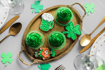 Tray with tasty treats for St. Patrick's Day celebration on table