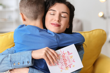 Little boy greeting his mom on Mother's Day at home