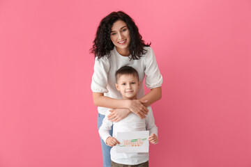 Little boy greeting his mom on Mother's Day against color background