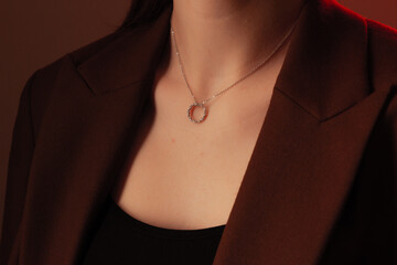 Cropped close up portrait of young woman with perfect silky skin, demonstrating silver jewelry...