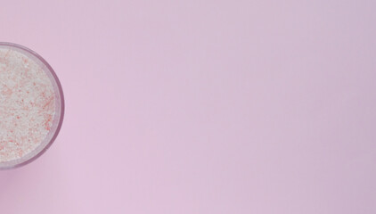 finely ground pink salt on a pink background