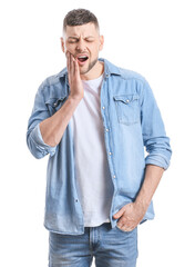 Man suffering from tooth ache on white background
