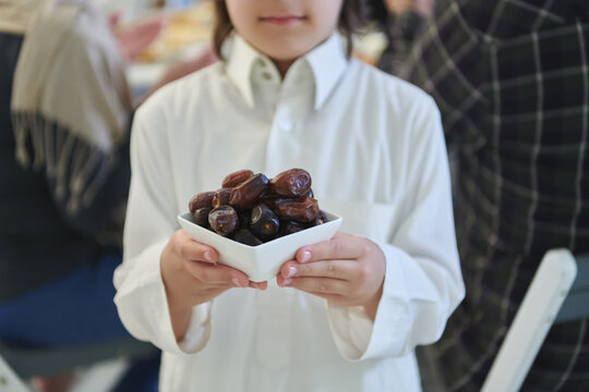 Arabian kid in the traditional clothes during iftar