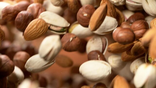 Super slow motion of flying nuts mix in rotating movement. Filmed on high speed cinema camera, 1000fps.