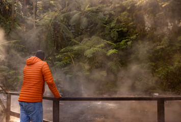 Man visiting Caldeira Velha, hot springs, Azores travel destination.