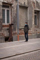 Adult man with mask, on the side street, during the coronavirus pandemic