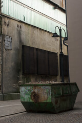 Debris container in the industrial area with old buildings