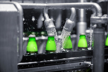 The process of filling beer into bottles on a production conveyor line